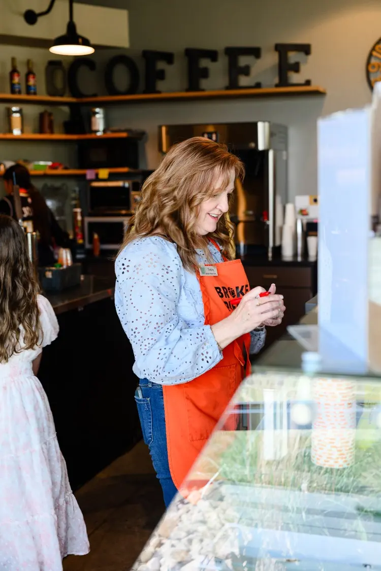 a woman with a barista apron working
