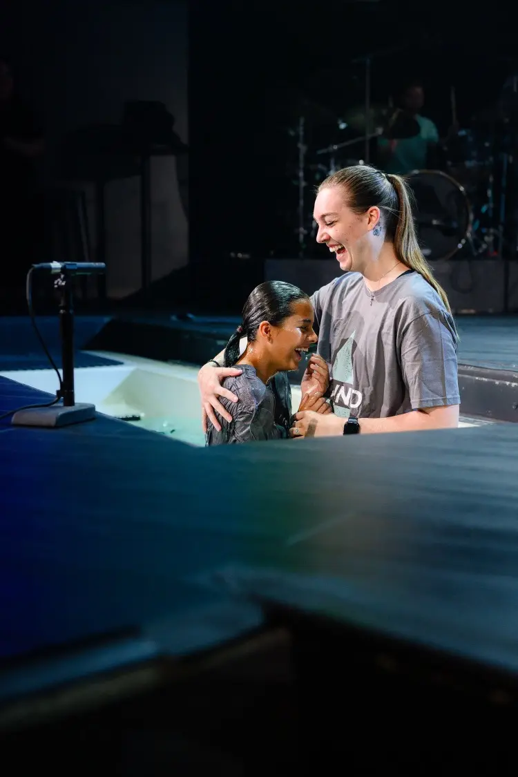 a young woman baptizing a girl