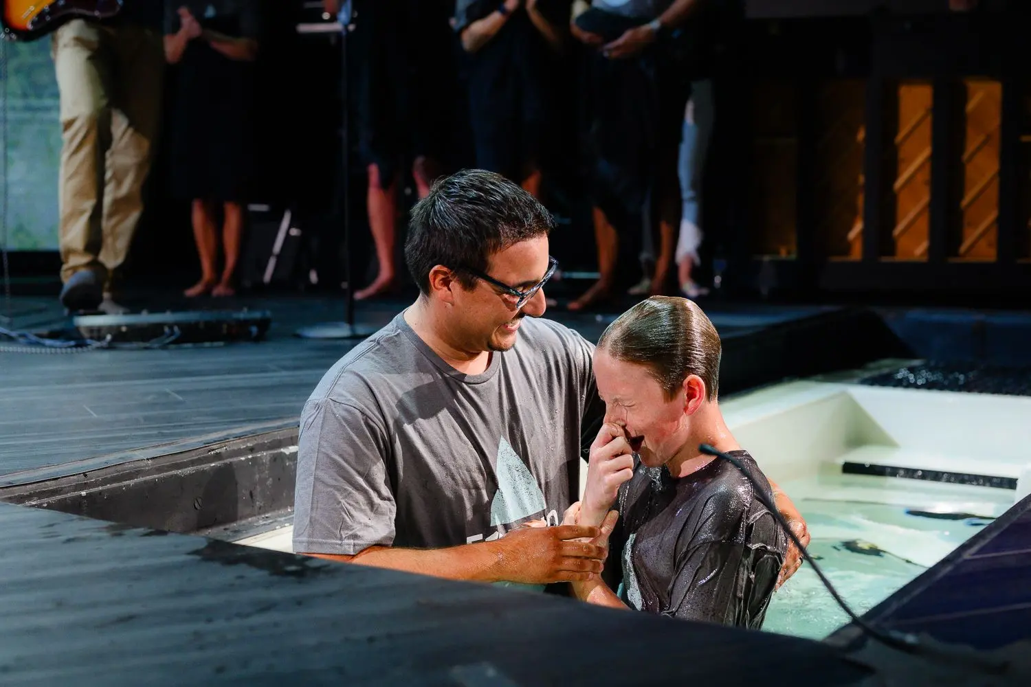 a man baptizing a young man