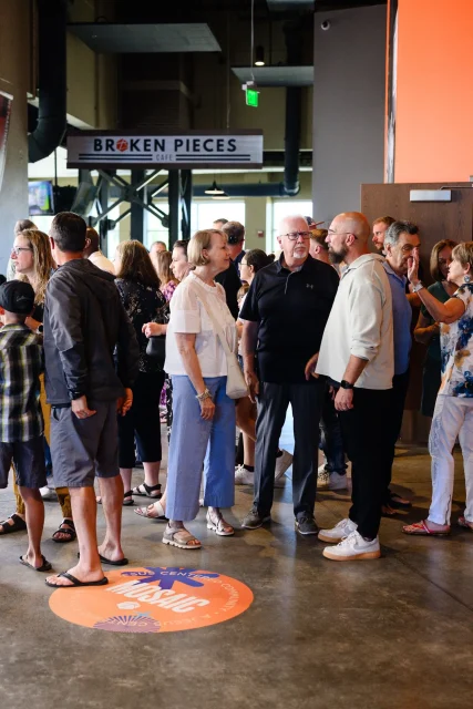a large group of people gathered in a church lobby