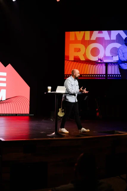 a pastor preaching on a stage
