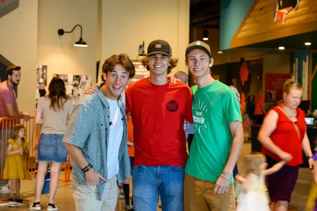 three young men posing for the camera