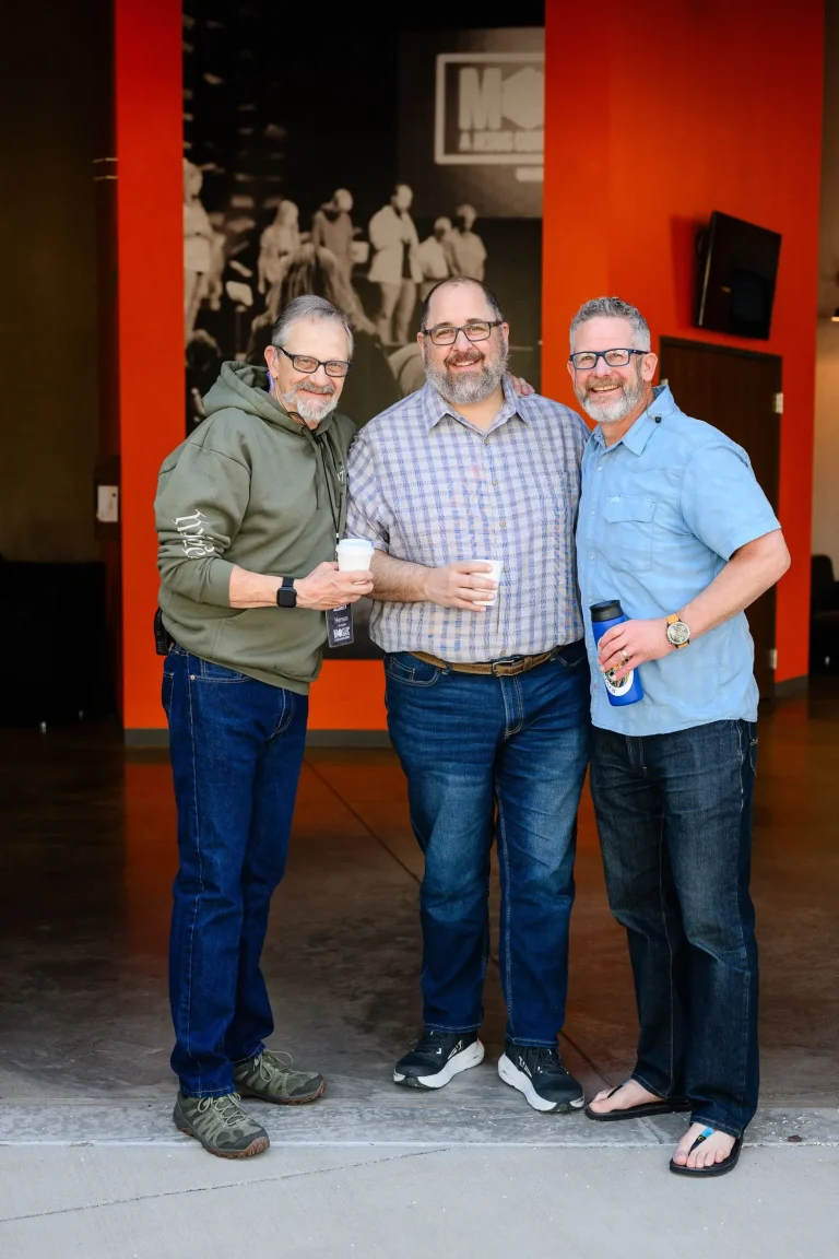 three men posing for the camera