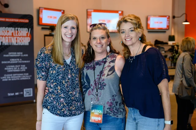 three women posing for the camera