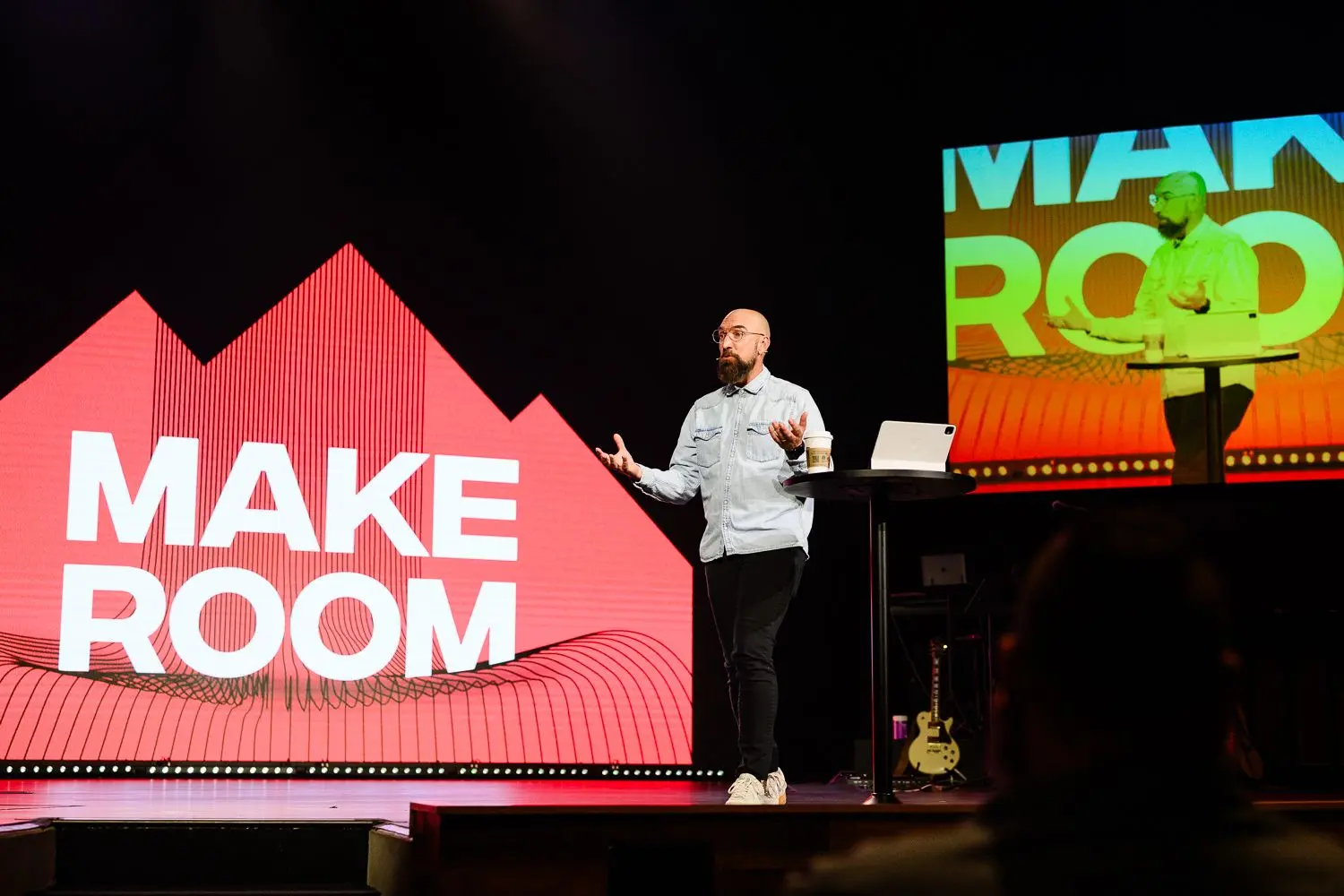 a pastor preaching on a stage