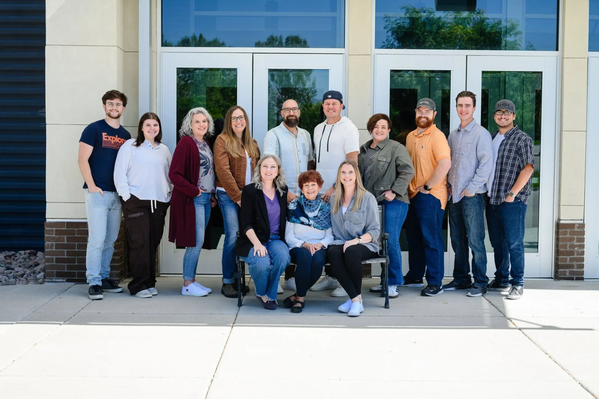 a church staff posing in front of the church doors