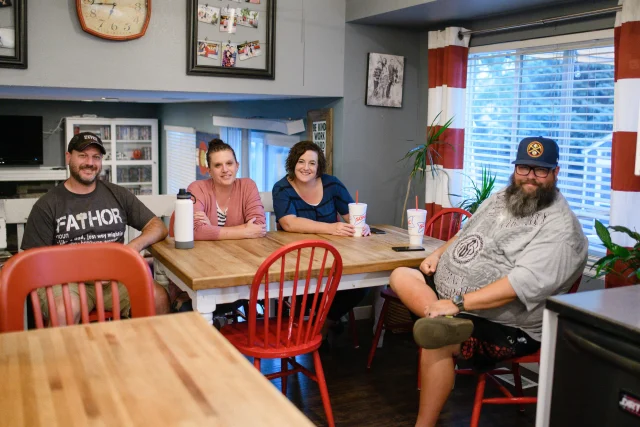 two couples posing at a dinner table