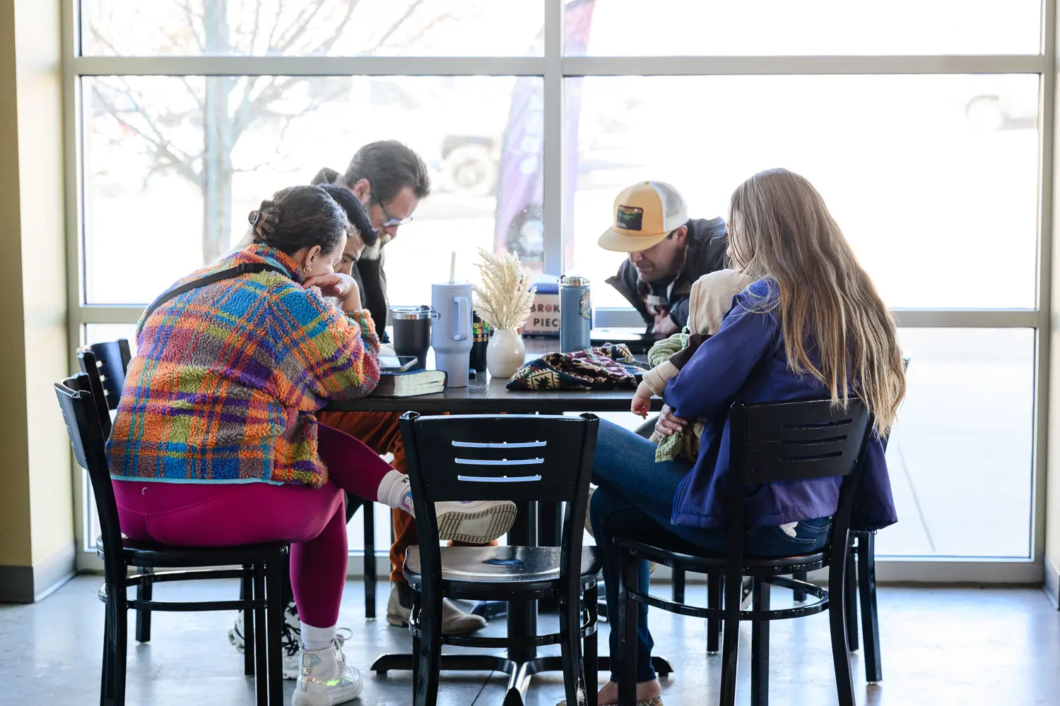 a group of people sitting at a cafe table