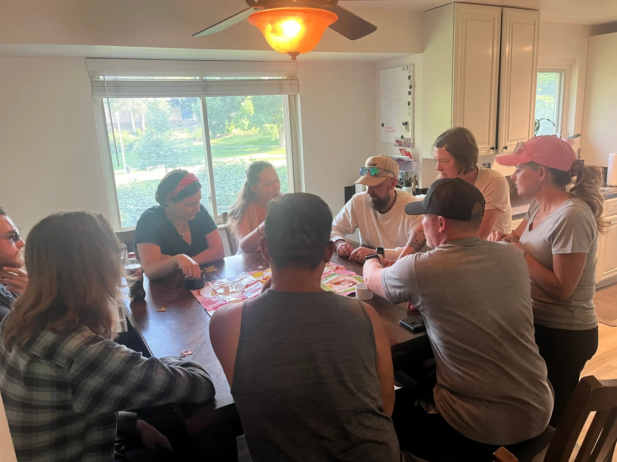 a group of men and women gathered around a dinner table