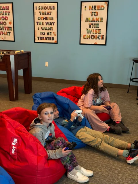 students playing video games on beanbag chairs