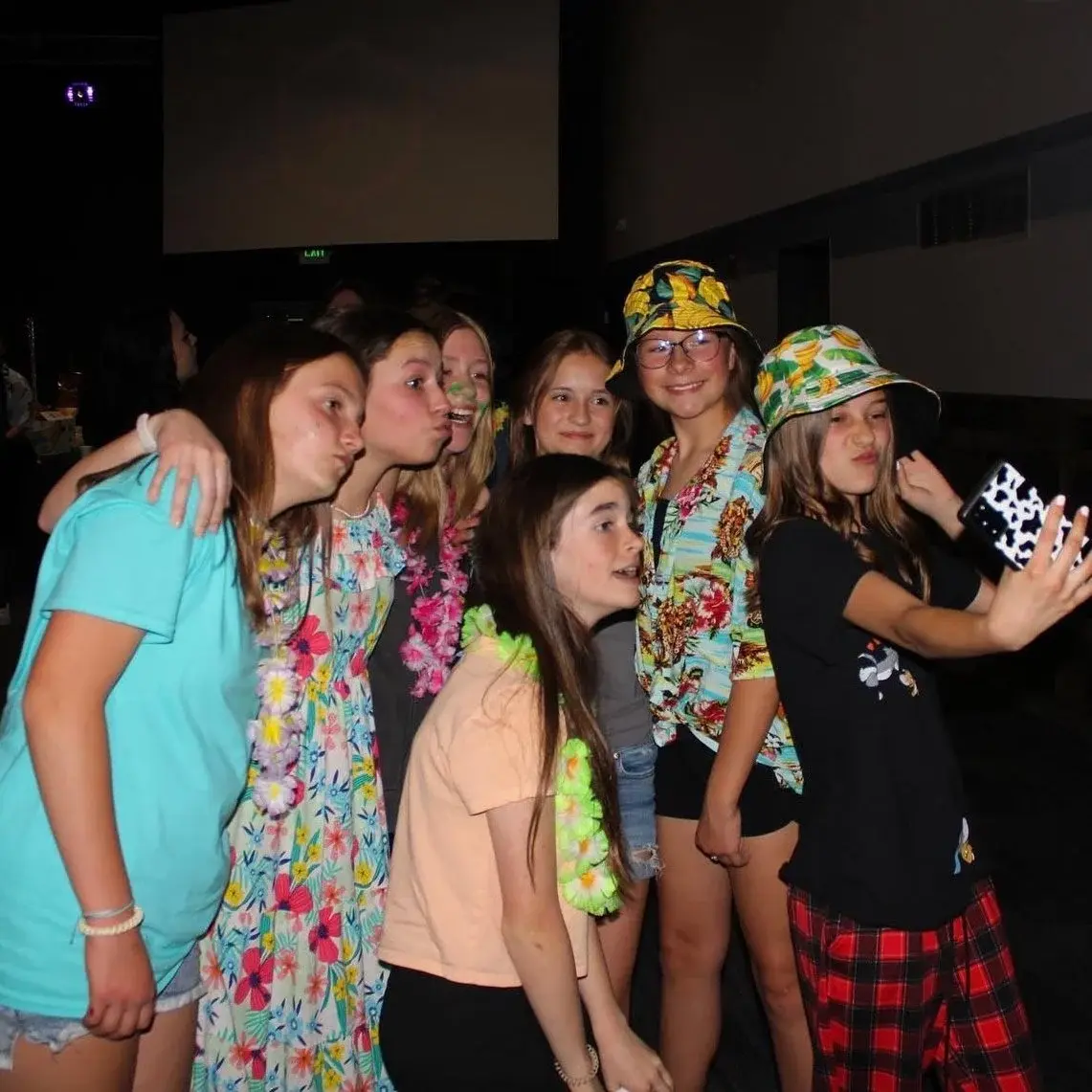 middle school girls taking a photo on a phone